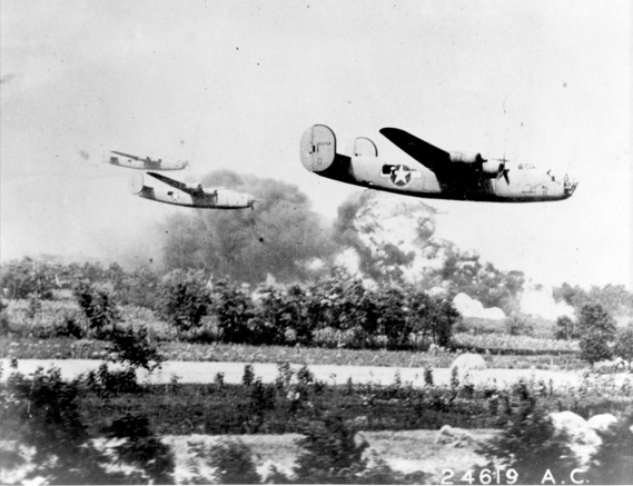 Allied forces B-24s fly at treetop level through their target area, the oil fields of Ploiesti, Romania. (Air Force photograph)