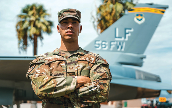 U.S. Air Force Staff Sgt. Christian Martinez, 56th Fighter Wing protocol specialist, stands in front of an F-16 Fighting Falcon, Aug. 20, 2024, at Luke Air Force Base, Arizona. (U.S. Air Force photos by Senior Airman Mason Hargrove)