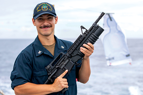 Gunners Mate 2nd Class Joshua Fajardoortez, from Las Vegas, Nev., poses for a photo aboard the Arleigh Burke-class guided-missile destroyer USS Ralph Johnson (DDG 114) in the South China Sea, September 27. Ralph Johnson is forward deployed and assigned to Destroyer Squadron (DESRON) 15, the Navy’s largest DESRON and the U.S. 7th fleet’s principal surface force. (Navy photograph by PO1 Jamaal Liddell)