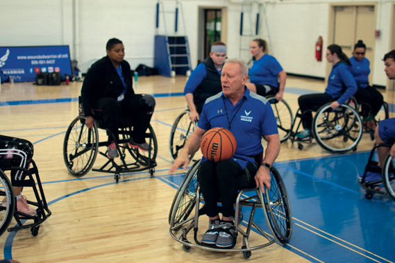 Mark Shepherd, AFW2 wheelchair basketball coach, talks to wounded warriors about the finer details of how to maneuver in a wheelchair during the NE Region Warrior CARE Event at Joint Base Andrews, MD. The biggest moving part of the AFW2 Warrior CARE Events is the adaptive sports. It's dynamic and fast-moving, giving each warrior an opportunity to see what they can do versus what they cannot. These wounded warriors often come to the events with a prescribed lists of things they cannot do and the coaching staff work hard to move around those mental barriers to increase their restorative care for long-term success in their overall recovery. (U.S. Air Force Photo by Shawn Sprayberry)