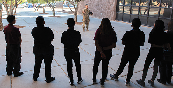 Students from Eldorado High School, listen to a briefing during a tour at Nellis Air Force Base, Nevada, Sept. 27, 2024. The tour was part of Air Combat Command’s Science, Technology, Engineering and Mathematics recruiting initiative called Project Quesada which aims to reach Hispanic serving institutions and minority serving institutions. (U.S. Air Force photo by Staff Sgt. Samantha Krolikowski)