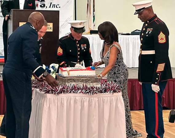 Marines and U.S. Air Force Col. Ahave Brown preside at cutting of ceremonial cake at Veterans Military Ball. (Photograph courtesy of Dee Black)