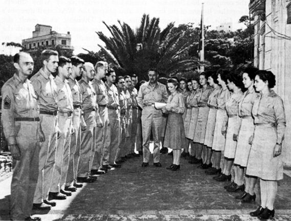 Maj. Martha Westray Battle Boyce, Women’s Army Auxiliary Corp Staff Director, North African Theater, reads orders replacing enlisted men of the adjutant general’s office with enlisted women, Algiers, North Africa. (U.S. Coast Guard photograph)